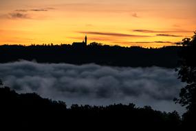 thick fog against the background of Andechs Monastery on the eastern shore of Lake Ammersee