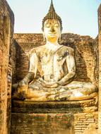 golden buddha statue on a temple in thailand