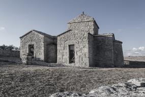 black and white photo of a stone church in sardinia