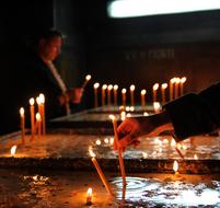 people light candles in church