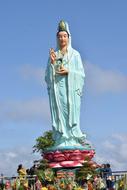 blue buddha statue on blue sky background