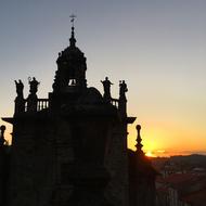 silhouettes of a monastery in spain at sunset