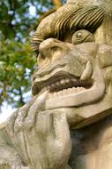 Beautiful sculpture of the dragon in China, near the green plants