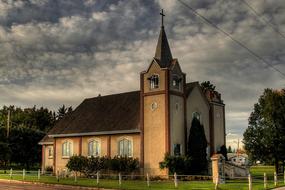 storm clouds over a church in canada