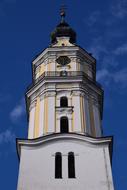 Beautiful bell tower with the steeple in DonauwÃ¶rth, Bavaria, Germany, under the blue sky with clouds