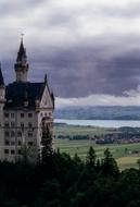 Beautiful landscape with church among the green plants, near the river, under the sky with clouds