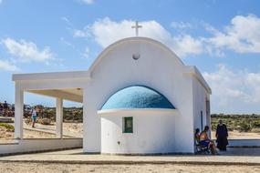 People near the beautiful church with the cross, on the Cavo Greko in Cyprus, Greece