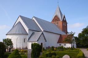 Beautiful and colorful Ballum church, among the colorful plants