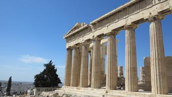 Beautiful Acropolis temple on the mountain, on landscape, under the blue sky with clouds