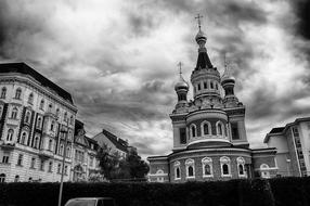 Black and white photo of the beautiful church in Vienna, Austria, under the clouds