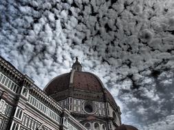 church with a dome under the clouds in florence