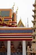 golden buddha statues under the roof