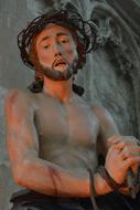 Jesus wearing crown of thorn, aged sculpture