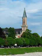 Beautiful landscape with Evangelische Christuskirche among the green trees, in Salzburg, Austria, under the blue sky with clouds