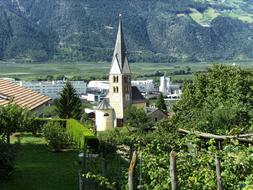 church with a spire in the valley in vetzan, Italy