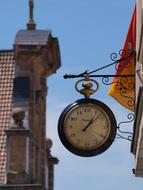 clock on the background of the church in the old town