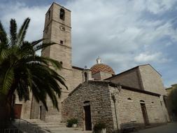 historic stone church near the palm tree