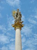 Madonna with a child on a white column