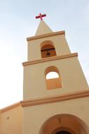 tower with a cross near the church