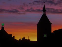 silhouette of a church with a spire during dawn