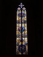 light stained glass window with pictures of saints