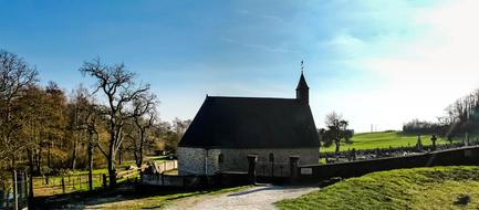 Beautiful landscape with the church among the colorful plants, in sunlight, in France
