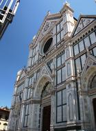 Beautiful and colorful church in Florence, Italy, in sunlight, under the blue sky