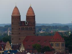 Beautiful and colorful St Paul's Church and other buildings in Ulm, Germany, among the green plants