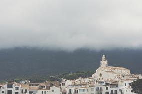 christian architecture in a village under a rainy sky