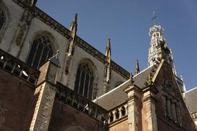 Beautiful church with the cross, in sunlight, in Netherlands, under the blue sky