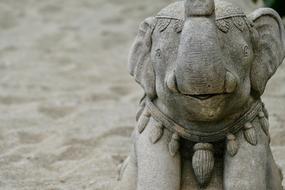 Beautiful sculpture of elephant, with the decorations, on the sand
