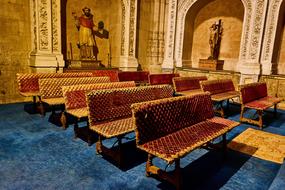 Beautiful interior of the cathedral in Salamanca, Spain, with statues and benches