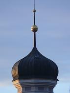 church tower with a spire on a blue sky background