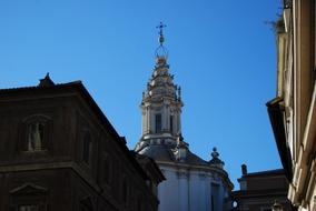 Beautiful Sant'ivo Alla Sapienza among the other buildings in Rome, Italy, under the blue sky