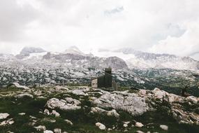 stone church on top of a mountain under the clouds