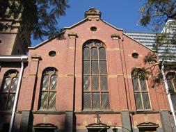 red brick church facade with arched windows