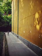 small boy walks along Temple Wall, china