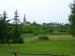 distant view of a church in green countryside