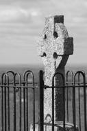 stone cross on a hill in ireland in monochrome