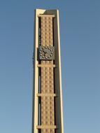 church clock on the tower against the blue sky