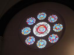 Close-up of the beautiful and colorful, round stained glass windows in the church, with patterns