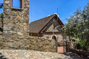 Beautiful and colorful church among the other buildings and plants in Lazanias, Cyprus, Greece, under the blue sky