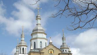 church with domes against the sky with clouds