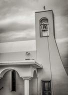 black and white photo of the bell tower on the church