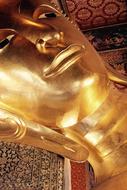 head of golden buddha statue close up