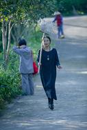 People on the path among the green plants