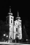 Black and white photo of the beautiful church with lights, at the night