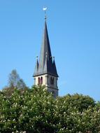 view of the church tower with a spire