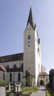 tower with a spire near a church in bavaria