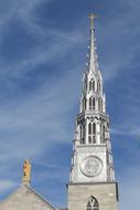 silver spire of the church against the blue sky